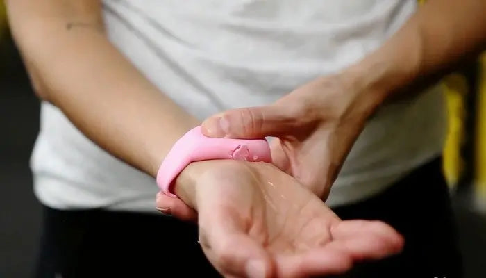 Squeezyband - adjustable wristband dispenser on wrist